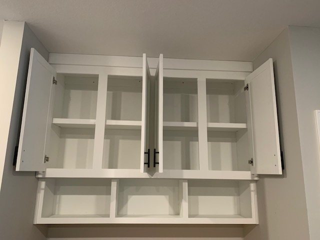Open custom storage cabinet with adjustable shelves and cubbies